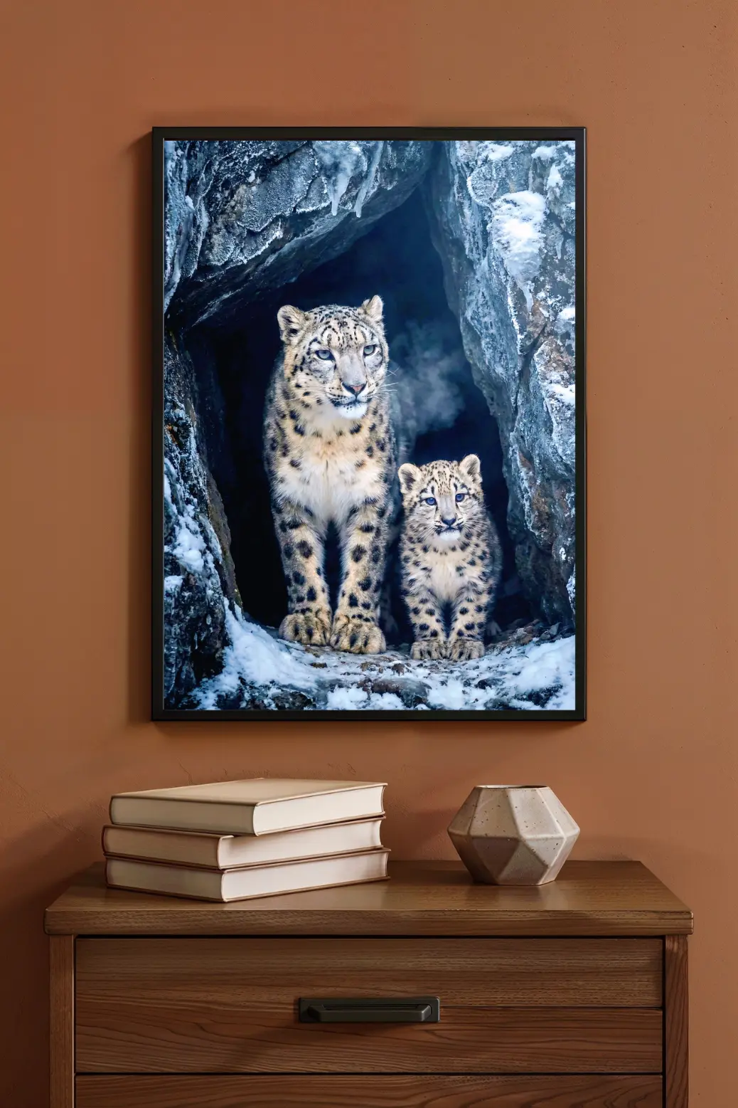 A stunning vertical high-resolution digital art poster featuring a majestic adult snow leopard standing protectively next to a small, fluffy cub inside a jagged, frost-covered ice cave in the Himalayas. The lighting is cool and moody with deep blues and crisp whites, highlighting the intricate texture of the leopards' fur against the frozen rock background, suitable for modern wall decor.