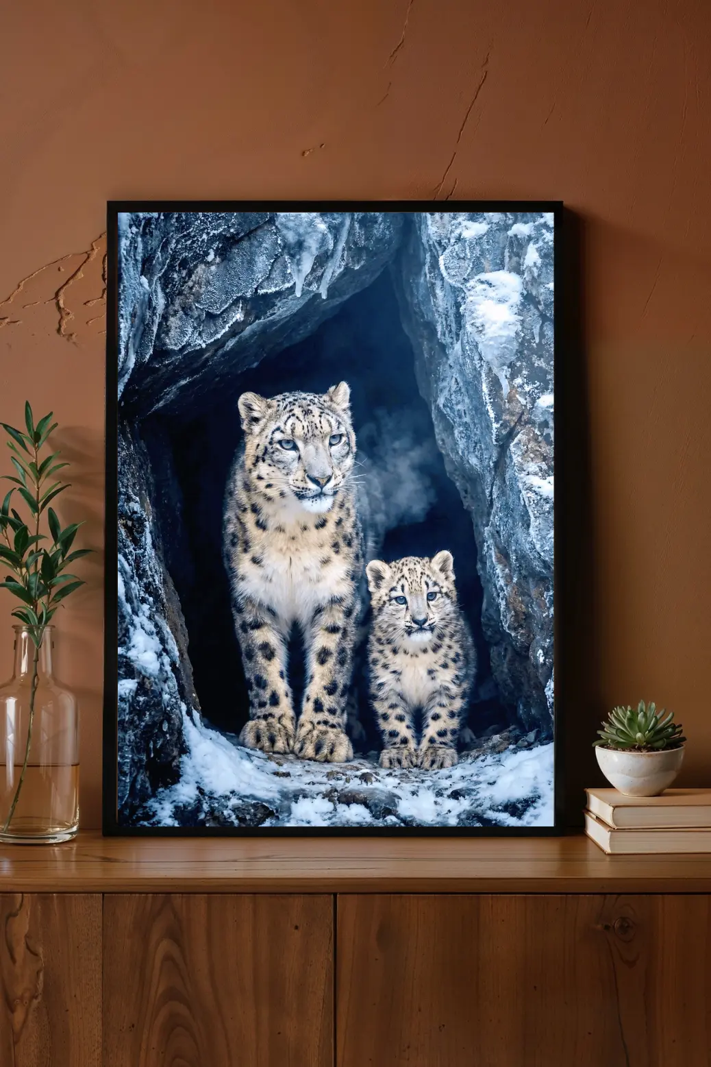 A stylish home office desk setup with the snow leopard art print leaning against the wall on a floating shelf next to a succulent plant. The image conveys a sense of focus and serenity, illustrating how the cool tones of the wildlife photography provide a peaceful visual break from a computer screen setup, perfect for a remote work environment.